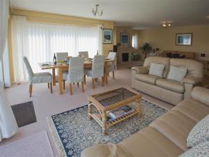 a living room with a couch and a table at Gull's Rest in Seaton