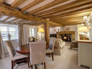 a dining room with a table and a fireplace at Sunnyside Cottage in Bampton