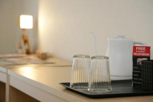two empty glasses sitting on a tray on a counter at goom Hotel Fukuoka-Kokusai-Center in Fukuoka