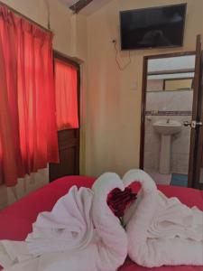 una camera con un letto con asciugamani e un lavandino di Hostal Tu Hogar a Cuzco