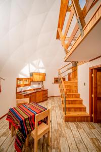 a room with stairs and a table and chairs at Tantakuy Eco Experience Hotel in La Huaica