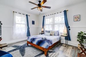 a bedroom with a bed and a ceiling fan at NEW Whaler Inn- Nautical Magic Hilo Downtown in Hilo +50 photos