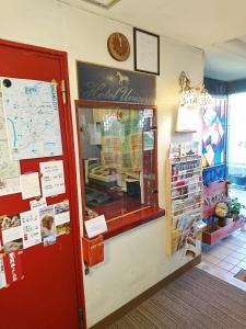 a shop with a window and a red door at Hotel Unicorn in Nagano