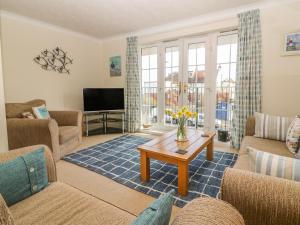 a living room with a couch and a table at Seascape in Bexhill