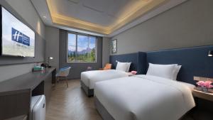 a hotel room with two beds and a television at Holiday Inn Express Beijing Badaling by IHG in Yanqing +46 photos