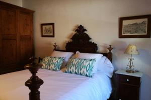 a bedroom with a large bed with white sheets and pillows at Casa Es Mercat in Sóller