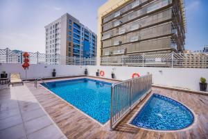 a swimming pool on the roof of a building at MENA Plaza Hotel Albarsha At The Mall in Dubai