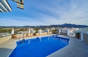 a swimming pool on the roof of a building at Hotel Bajamar Centro in Nerja