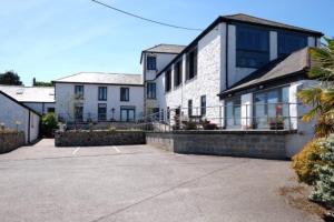 a large white house with a large balcony at Copperhouse View in Hayle