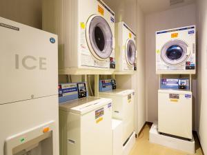 a laundry room with two washes and other appliances at Hotel Monterey Kobe in Kobe