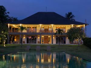 a house with a pool in front of it at Balian Prana in Selemadeg