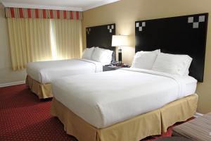 two beds in a hotel room with white sheets at Holiday Inn Express Van Nuys, an IHG Hotel in Van Nuys