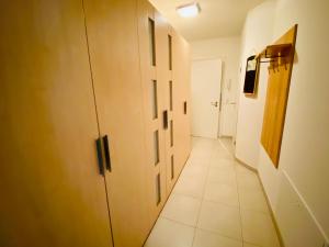 a hallway with doors and a tiled floor at Villa Seepark - Ferienwohnung 2 in Heringsdorf