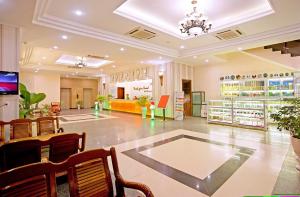 a large room with chairs and a store at Bamboo Green Central Hotel in Da Nang