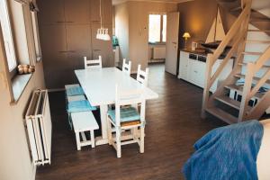 a kitchen and dining room with a table and chairs at Residentie Duindoorn in Koksijde