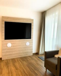 a living room with a flat screen tv on a wall at Ferienwohnung Fichtelzauber in Mehlmeisel