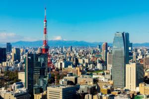 a view of a large city with a tall tower at Park Hotel Tokyo in Tokyo