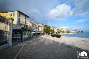 a cobblestone street next to a body of water at Romantic Benaco Salò in Salò