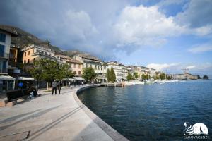 a city with a body of water and buildings at Romantic Benaco Salò in Salò