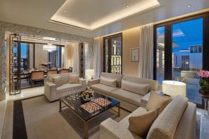 a living room with a couch and a table at Mandarin Oriental, Doha in Doha