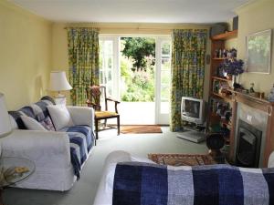 a living room with a couch and a fireplace at Winterbourne Cottage in Chilmark