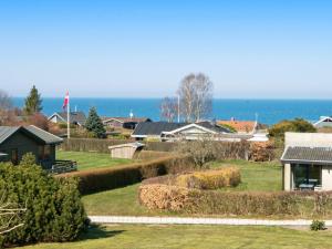 a view of a house with the ocean in the background at 6 person holiday home in Alling bro in Rygård Strand