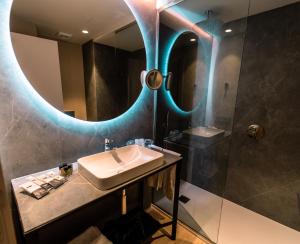 a bathroom with a sink and a mirror at Hotel Taburiente S.C.Tenerife in Santa Cruz de Tenerife