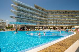 a swimming pool in front of a hotel at Aqua Nevis Hotel & Aqua Park - All Inclusive in Sunny Beach