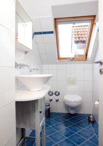 a bathroom with a sink and a toilet at Landhaus Residenz Kirchsee Morgenstern in Insel Poel +16 photos