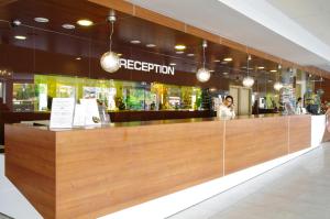 a restaurant with a large wooden reception counter at Aqua Nevis Hotel & Aqua Park - All Inclusive in Sunny Beach +63 photos