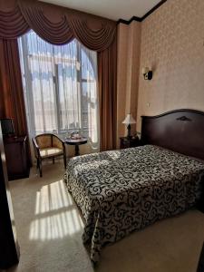 Кровать или кровати в номере Hotel Carol