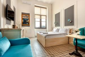 a bedroom with a bed and a couch and a table at Cezayir Rooms in Istanbul