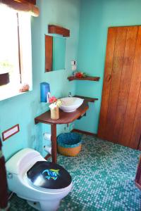 a bathroom with a toilet and a sink at Hotel Ecolodge Riake Resort & Villa in Sainte Marie