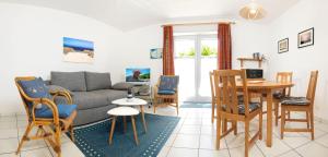 a living room with a couch and chairs and a table at Buchenweg Whg.24, Friese, EG re in Insel Poel