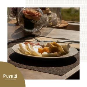 um prato branco de comida numa mesa em Puralã - Wool Valley Hotel & SPA em Covilhã