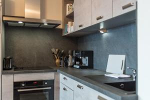 a kitchen with a counter top with a coffee maker at ODYSSEE B102 Cosy appartement sur les pistes in La Toussuire