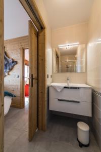 a bathroom with a sink and a mirror at ODYSSEE B102 Cosy appartement sur les pistes in La Toussuire