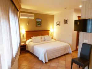 מיטה או מיטות בחדר ב-Hotel-Restaurante La Quadra
