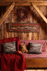 a couch with two teddy bears sitting on it at Residence Hôtelière La Renardiere in Samoëns