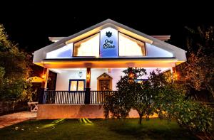 a white house with a sign on it at night at Only Blue Villa in Göcek