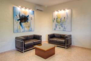 a waiting room with two leather chairs and a table at Hotel Club Sunway Punta Prima in Es Pujols