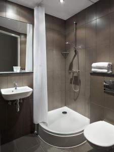 a bathroom with a shower and a toilet and a sink at The Social Hub Amsterdam West in Amsterdam