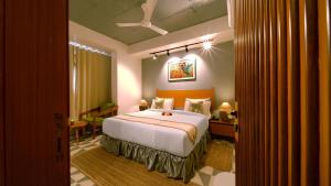 a bedroom with a large bed in a room at Hotel Nova Boutique in Rajkot