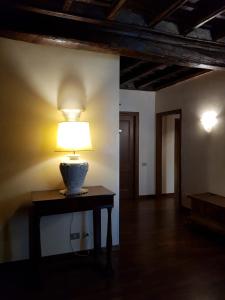 a lamp sitting on a table in a room at Domus Julia in Rome