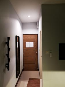 a room with a door leading to a hallway at Skyline Resort in Ban Khlong Lat Bua Khao