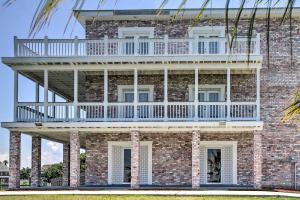 a brick building with a balcony on top of it at Waterfront NOLA Villa 23 Mi to French Quarter! in Venetian Isles