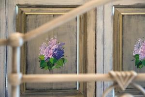 a picture of purple flowers in a mirror at Palaeopoli Villas in Avlemonas