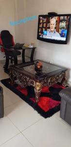 a living room with a coffee table and a tv at ONNIE GUESTHOUSE in Louis Trichardt