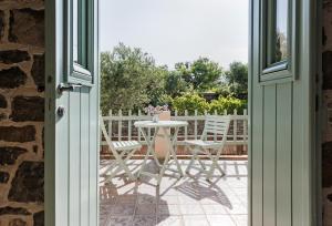 a patio with a table and chairs in a yard at Palaeopoli Villas in Avlemonas