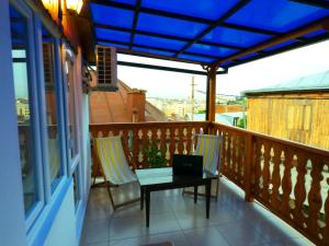 a balcony with a table and a laptop on it at Hotel Formula-1 in Tbilisi City